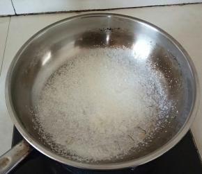 在把白糖倒入锅中，小火。