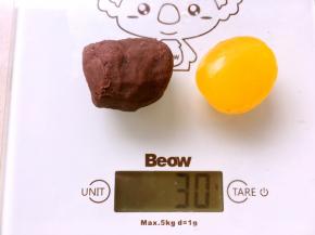 取一个凉透的咸蛋黄，跟豆沙一起称重30克
