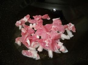 锅里放油，炒香蒜泥，加猪肉丝翻炒