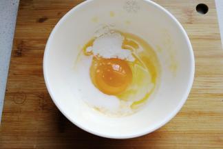 鸡蛋一个打入碗中，加一点点牛奶和一勺淀粉搅拌均匀（两个鸡蛋分次进行，一个鸡蛋正好摊一张蛋饼）