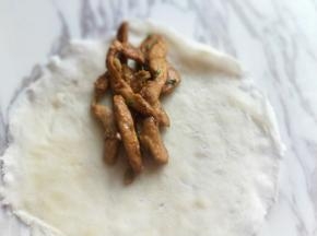 将做好的鸡柳放在饼上。