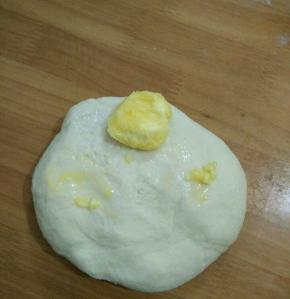 然后用手和成团，用力揉到初步扩展时加入黄油。继续用力揉、揉、揉……
