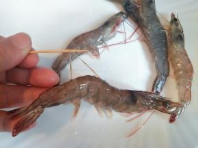 明虾背后剪开，用牙签挑去沙线，剪掉须脚