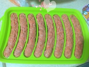 香肠模具抹油，裱花袋剪口，挤入肉馅，抹均匀。