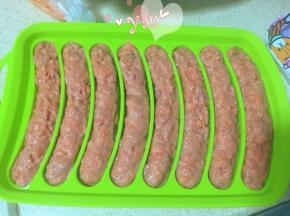 香肠模具抹油，裱花袋剪口，挤入肉馅，抹均匀。