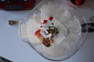 草莓同酸奶、南瓜子一起放入搅拌杯内；