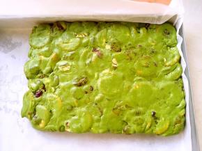 烤盘铺油纸，趁热将翻拌均匀的雪花酥放到模具内，整理成方形，可以借用刮板将四周推平正