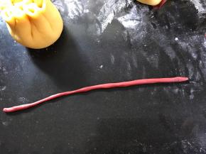 取一小块红色面团搓成线条。