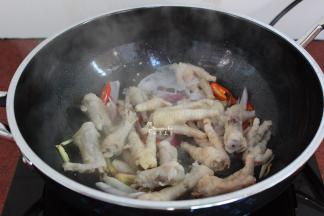 起皱的鸡爪捞出，沥干水，倒入锅中；