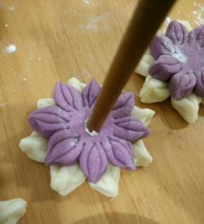 用一根筷子先沾点水再沾芝麻，轻轻压在花的中心。全部做好再饧半小时入锅蒸15分钟焖五分钟出锅。