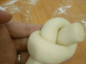 把其中一端转个圈，然后端头从中间穿出来。