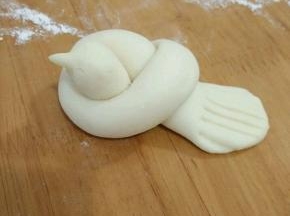 然后捏出小鸟的嘴巴，尾巴用剪刀修剪一下，再用叉子压出纹路。