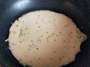 平底锅中刷上少许食用油，盛一勺面糊，快速来回画圈平底锅，使面糊均匀成圆形状态。