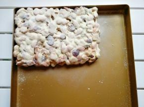 把雪花酥放烤盘整形，再撒上一层奶粉