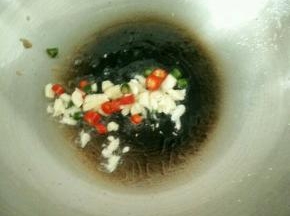 重新起锅烧热放油，放入蒜头和辣椒，爆香。