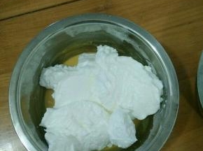 取三分之一蛋白糊放到蛋黄糊里，翻拌均匀。同时，烤箱预热。