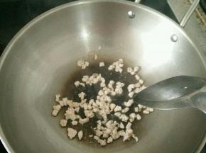 热锅凉油下猪肉丁，加点料酒。