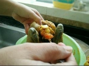 然后把拌好食材塞到鸡肚子里。再把鸡爪也塞进去。