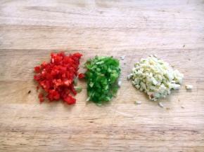 将辅助食材青红椒、蒜切成末。