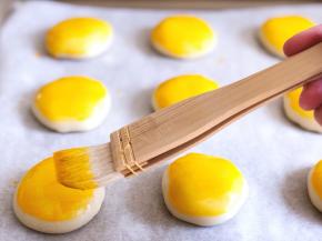 放入铺了油纸的烤盘内，刷上蛋黄液