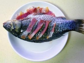 把火腿片嵌入鱼身，多余的铺在边上
