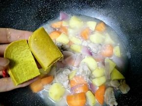 把咖喱掰成小块，放入锅中