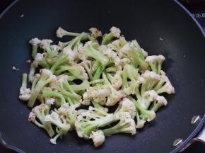 热油锅，放入花菜煸炒至微焦黄出锅待用
