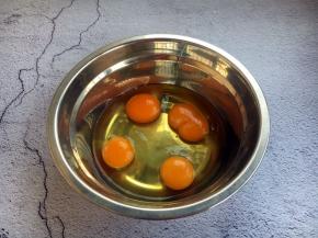 将鸡蛋磕入小盆中。