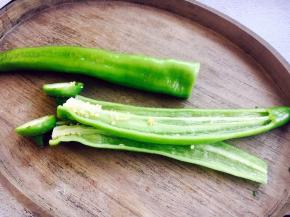 青椒切去根部，一破为二，摘去青椒籽。