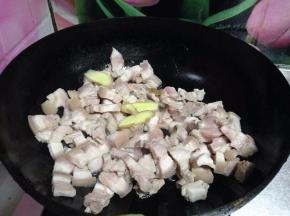 锅中用少许葱油爆香葱、姜、蒜片，将五花肉丁放入锅中