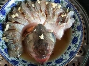 把切好的蒜撒在鱼身上，隔水蒸12-15分钟，关火焖3分钟。
