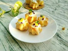 泡芙凉凉后切去三分之一，挤上奶油。