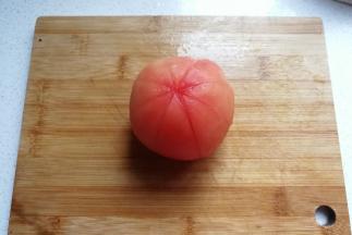 再把番茄打上米字花刀，割口要深到皮下