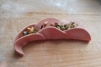 再立起来，从左端开始向内卷起来，收尾处捏紧沾点水粘紧