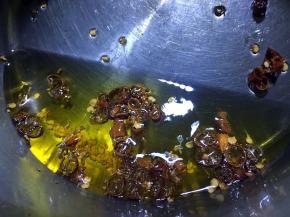 锅内放油烧至四成热熄火，放入辣椒碎炒香