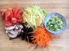 将圆白菜切丝，胡萝卜切丝，木耳切丝，香菇切丝，西红柿切块，小香葱切成葱花。