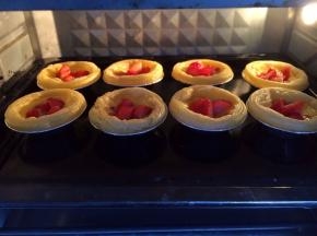 放入草莓块后，再将烤盘放回烤箱，继续再烤10分钟。蛋挞烤好了，拿出来晾一会儿就可以吃了。