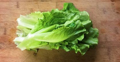 把生菜放在案板上，只取绿色部分