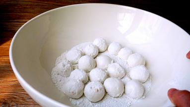 将包好的汤圆放进干糯米粉盆内，轻轻转动盆子，使每个元宵都均匀的裹一层糯米粉