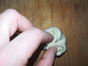 收口朝上，两手将两边往中间捏。