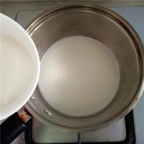 将搅拌好的糯米粉水倒入杏仁浆中，一边煮一边搅拌。