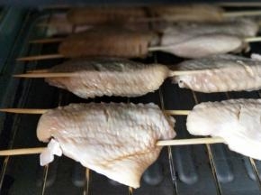 依次串好，依次摆放在烤网上，放入烤箱，上火200度烤15分钟。(烤网下面需要放烤盘，鸡翅经高温烤，会有油脂流出，所以下面需要放烤盘，烤盘里可以装一点水，这样烤盘比较容易清洗)