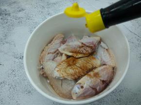 鸡翅放入一个容器，加生抽一勺，料酒一勺，盐一勺
