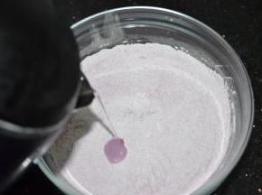 往紫薯糯米粉里加入开水，一边加一边搅拌