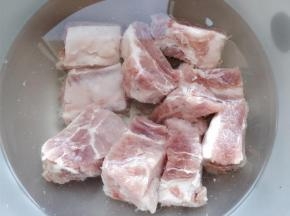 将猪肋排剁成小块，放入冷水中泡出血水后倒掉。这样做熟的肉不会腥，也不会硬。