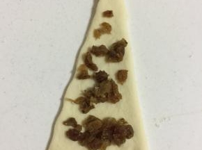 取一个面片，均匀的铺上切碎的葡萄干。