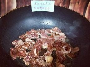 起油锅，加入切好的葱，姜，蒜，辣椒炒香，再将腌制好的牛肉倒入锅中，快速翻炒。