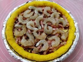 上面撒紫洋葱碎，培根条，铺虾仁，入烤箱200度烤10分钟