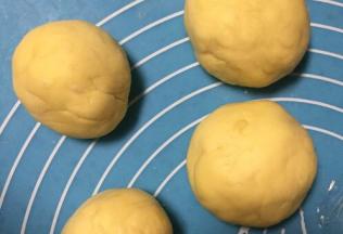 将面团取出排气，分成四份盖上保鲜膜醒发面团15分钟