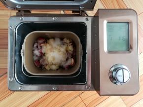 在山楂上放上150克的糖，启动面包机的果酱功能开始熬果酱